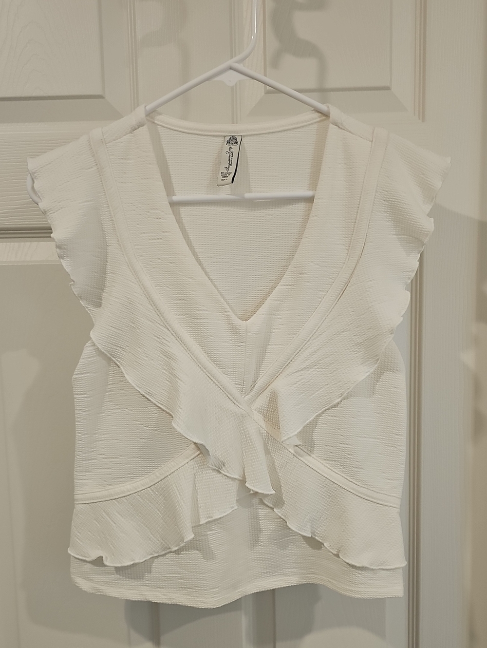 White Sleeveless Criss Cross Ruffle Blouse
